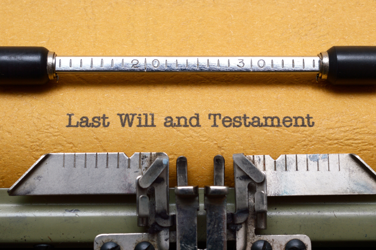 Image of a will in a typewriter for a blog post answering the question, "do you need a will."