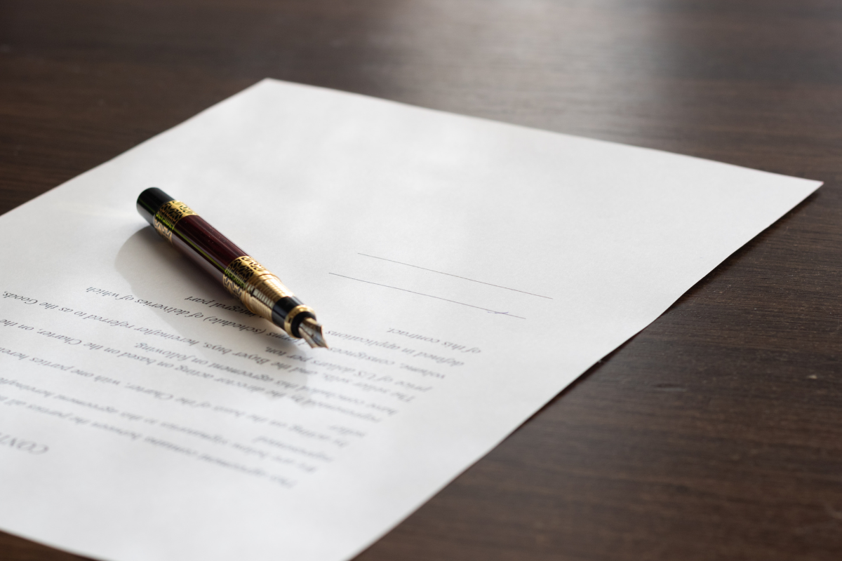 Image of an estate management document on a desk with a pen for a blog post covering how to get a death certificate.