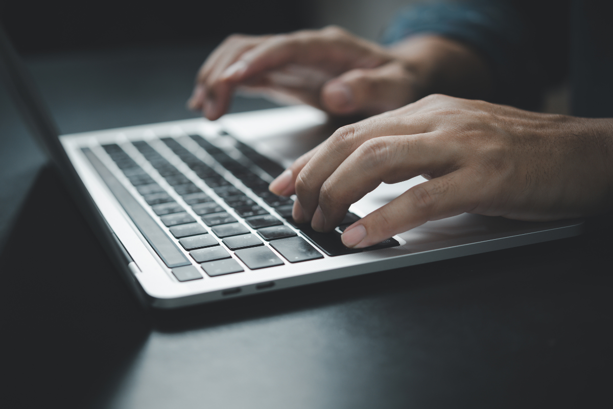 Image of a man working on a laptop for a blog post answering the question "what is a probate bond?"