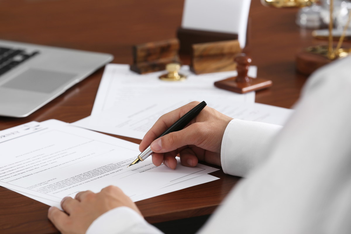 Image of a judge reading over letters of testamentary at a desk.