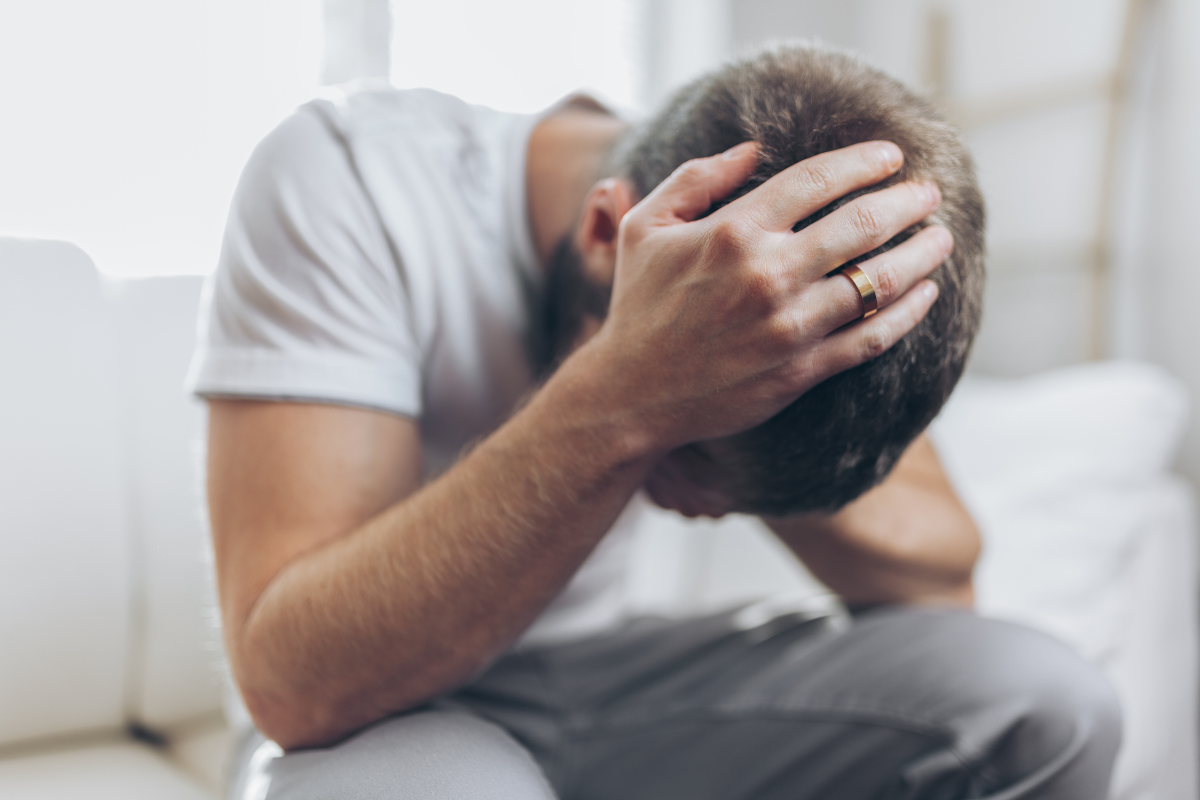 Image of a man affected by a recent loss in the family for a blog post about managing grief and responsibility.