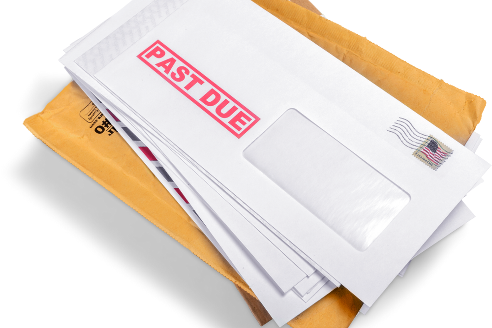 Image of a stack of bills and statements, symbolizing the responsibilities faced when settling a loved one's bills.