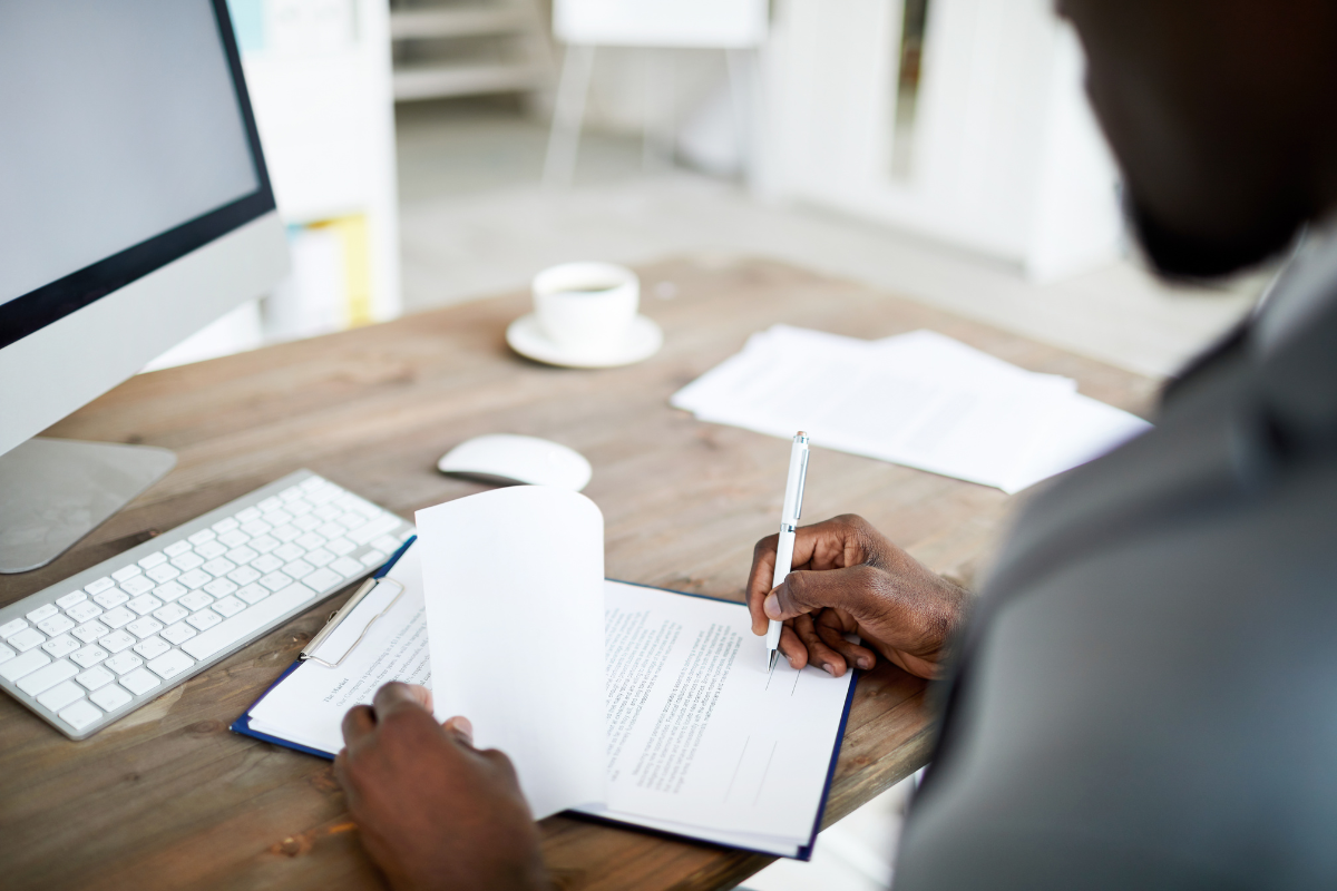 Image of a banker at his desk preparing a document for an article answering the question, "what is a medallion signature."