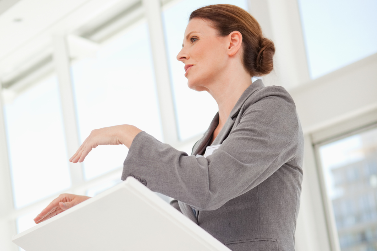 Image of a woman delivering a eulogy for a loved one for a blog post on how to write a eulogy.