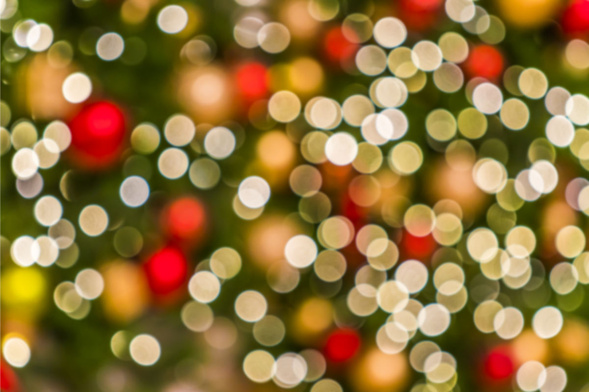 Image of blurred Christmas lights in the background for a blog post discussing mourning during the holidays.