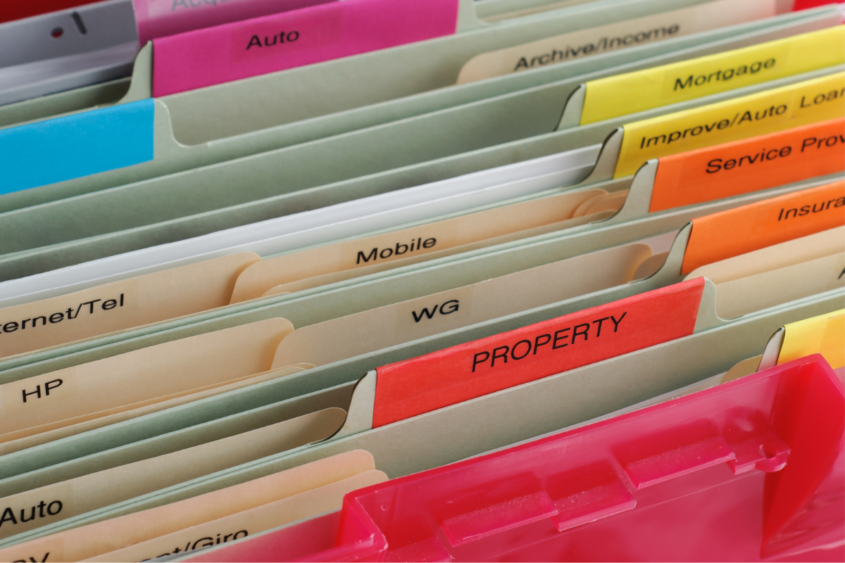 Image of file cabinet folders containing personal documents for a blog post covering organizing estate documents.
