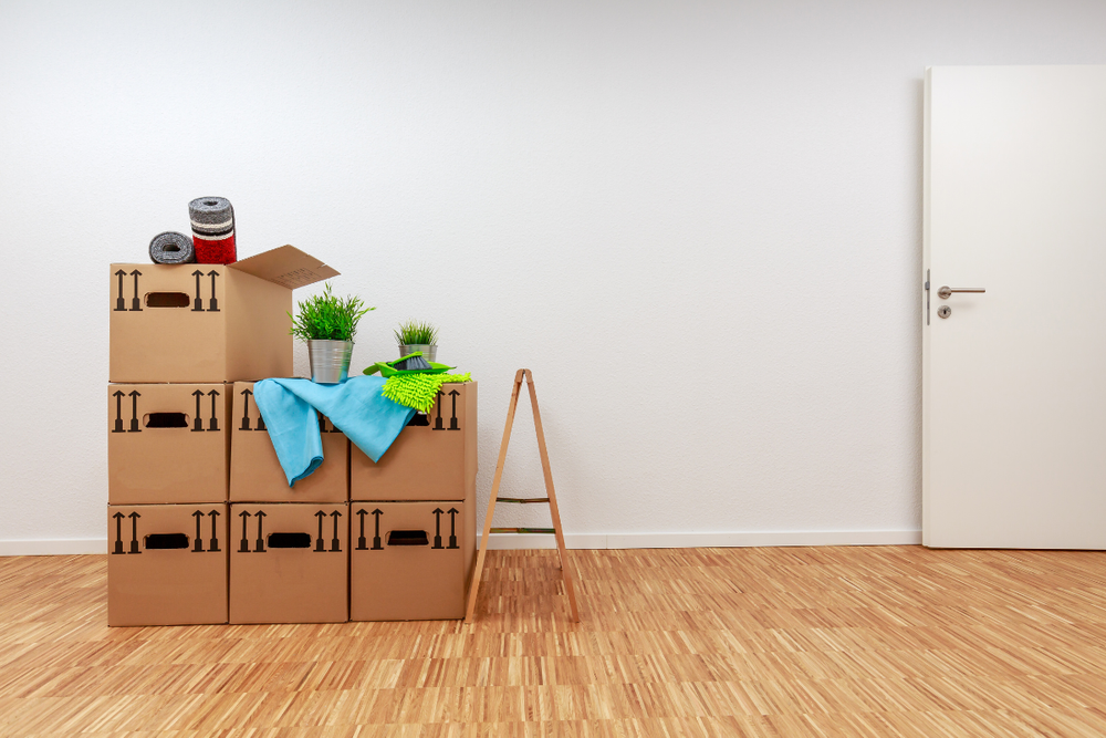 Image of packed up boxes in a small apartment for a blog post covering sorting through a loved one's belongings.