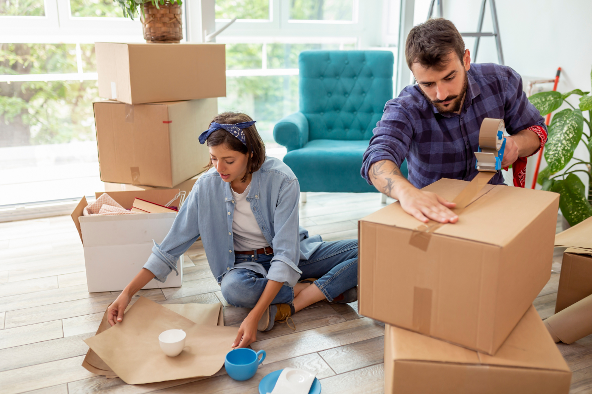 Image of a man and a woman packing up household items for estate donations.