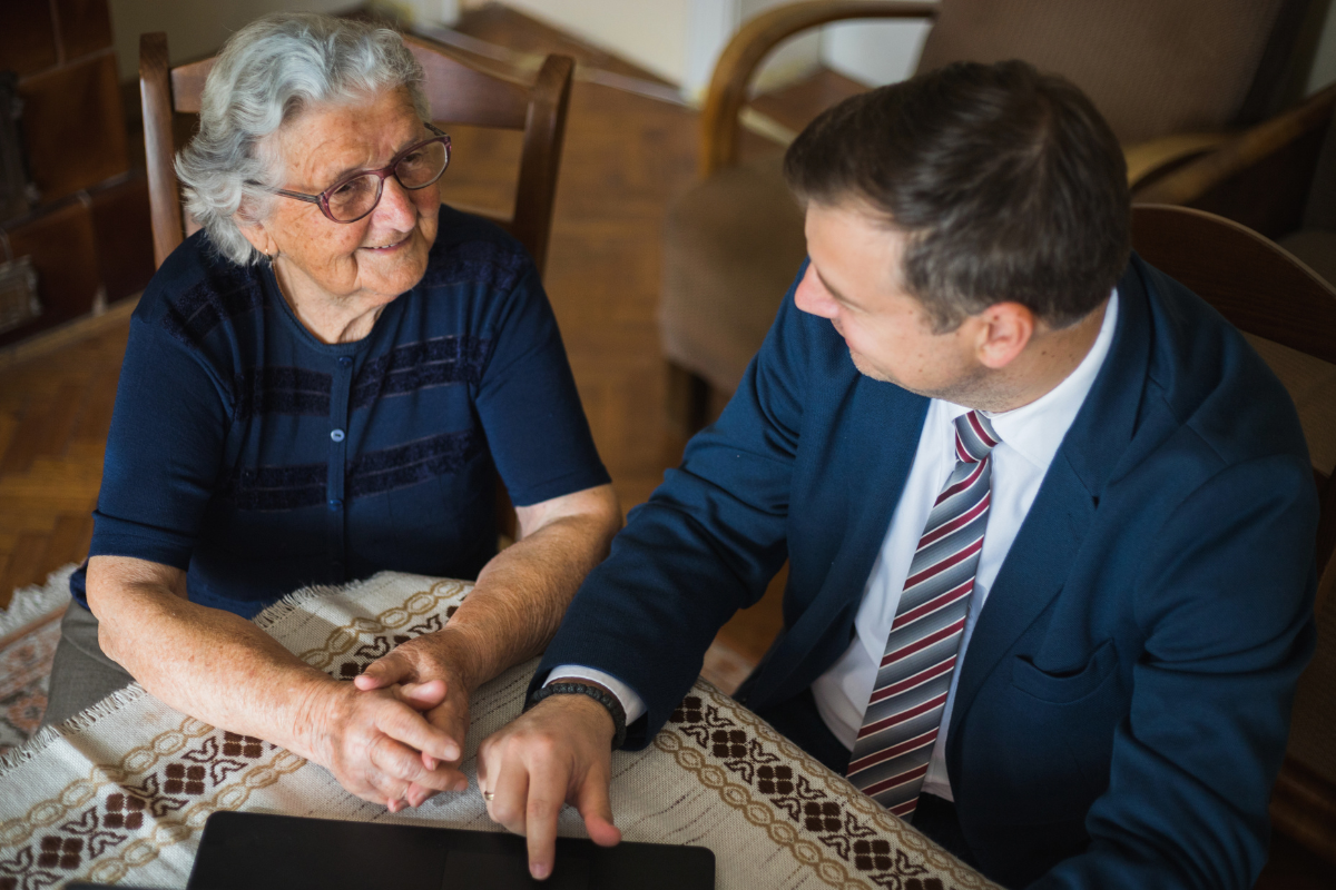 Image of a lawyer meeting with a client in their home for a blog post answering the question, "What is probate?"