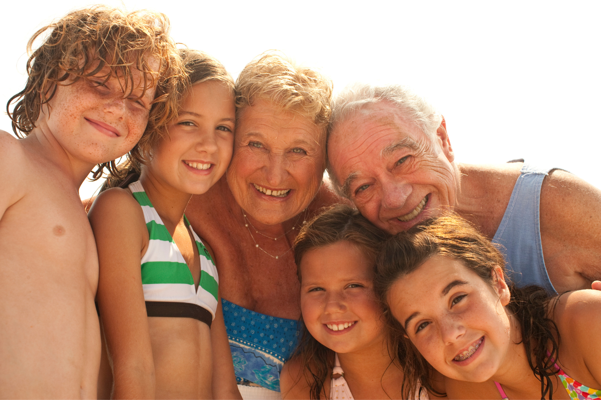 image of grandparents and their grandchildren for a blog post that explains Primary Beneficiary vs Contingent Beneficiary.