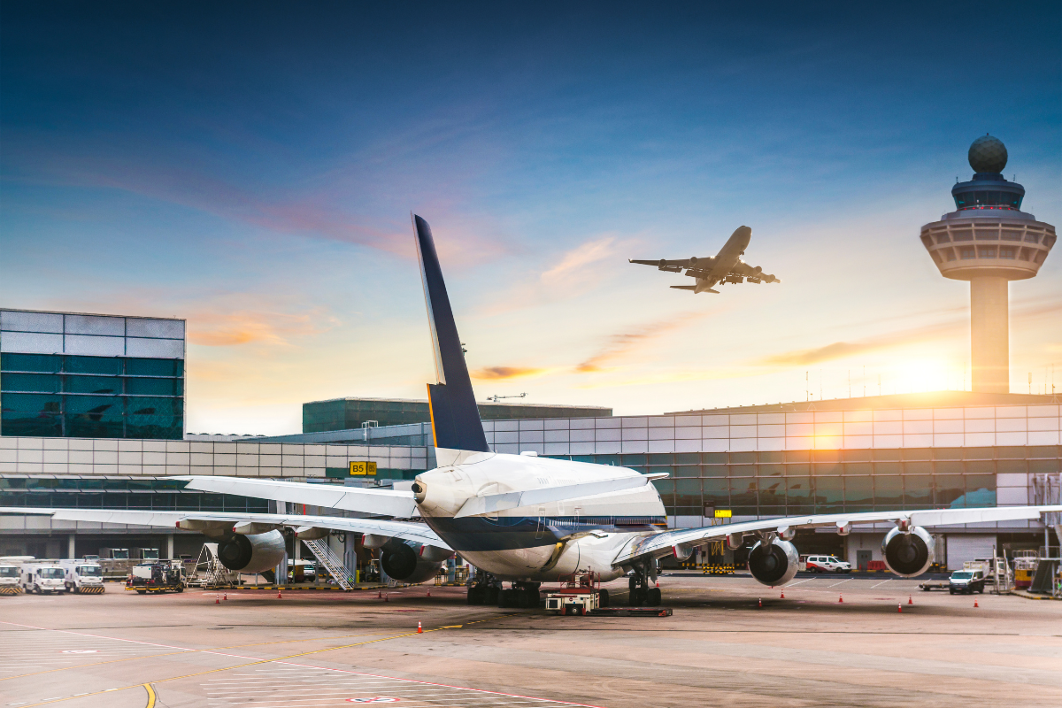 Image of an airliner parked at the airport for a blog post answering the question "can you inherit airline miles?"