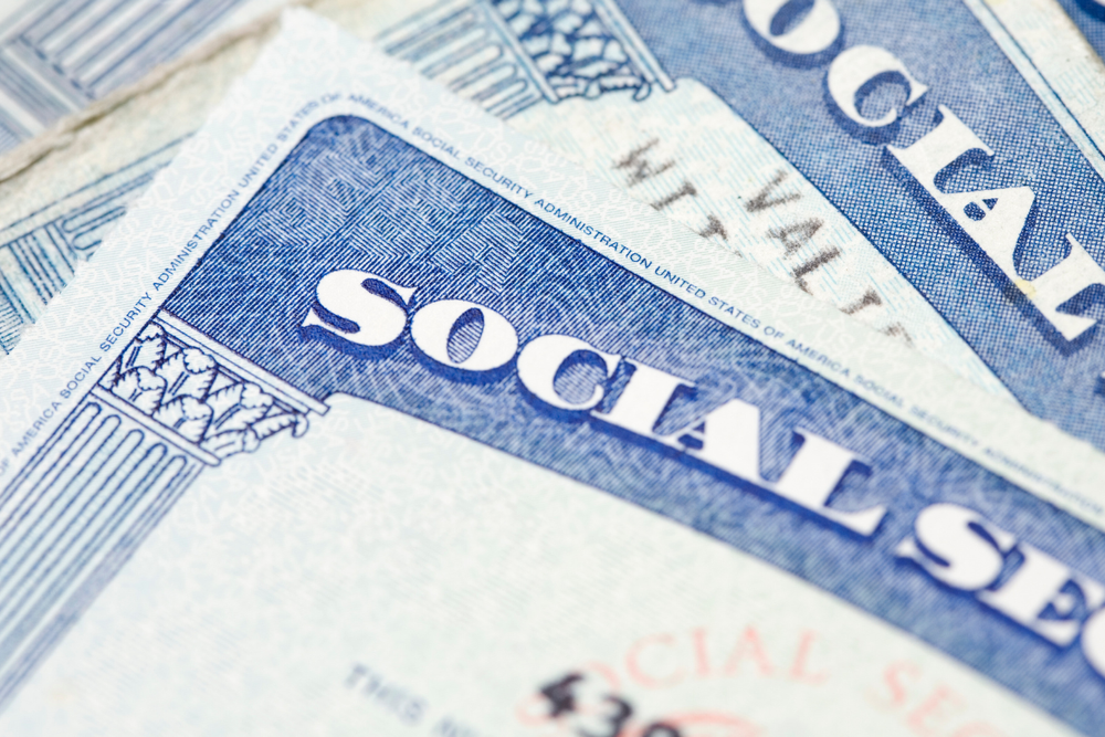 Image of a stack of Social Security cards for a blog post answering the question "does Social Security cover funeral expenses?"