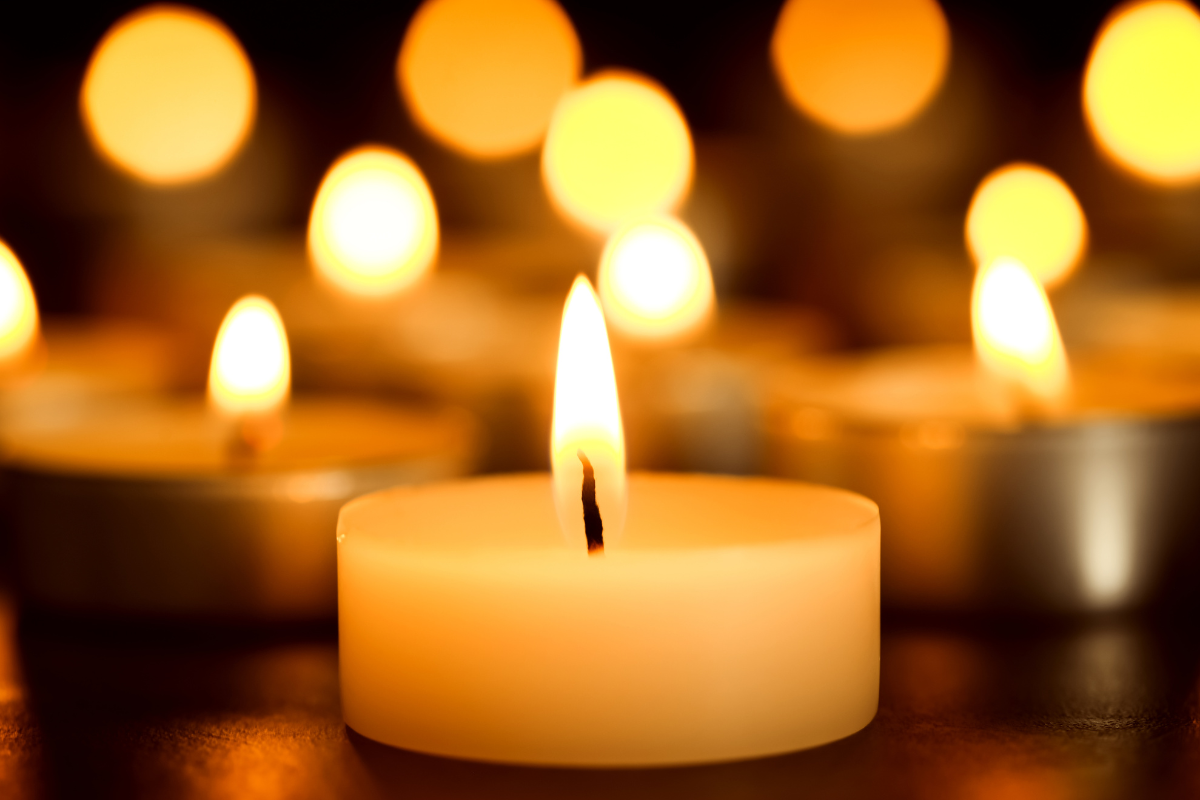 Image of lit votive candles for a blog post covering how to plan a funeral.