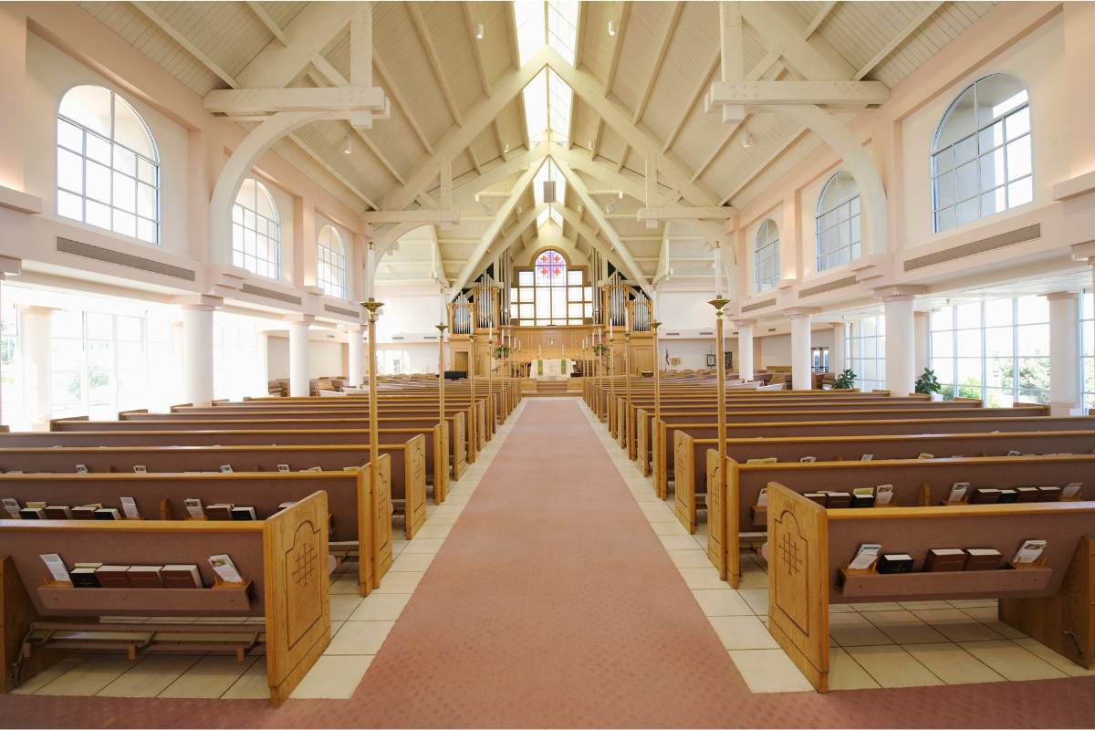 Image of the pew and aisle of a church for a blog post about pallbearer planning for a funeral