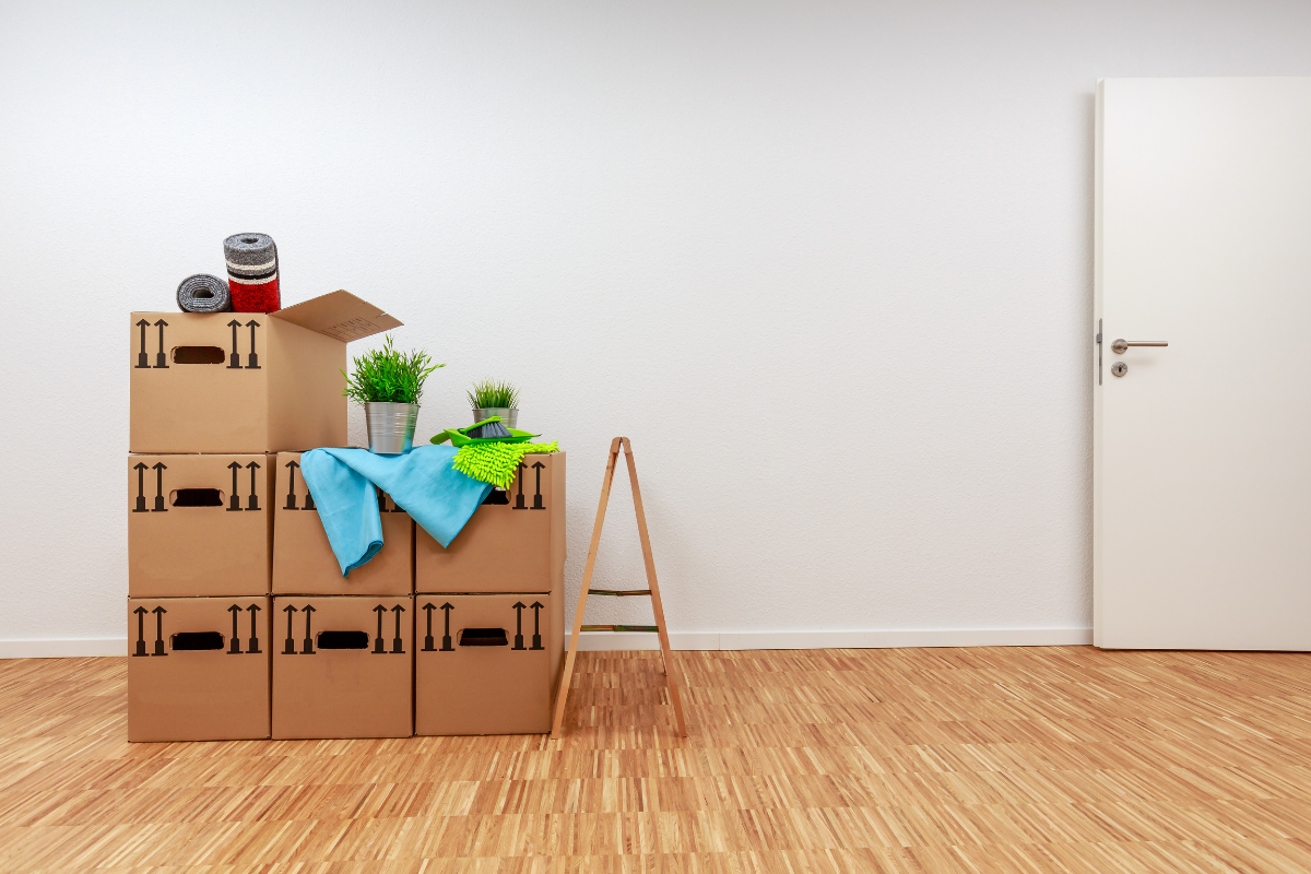 Image of packed up boxes in a small apartment for a blog post covering sorting through a loved one's belongings.